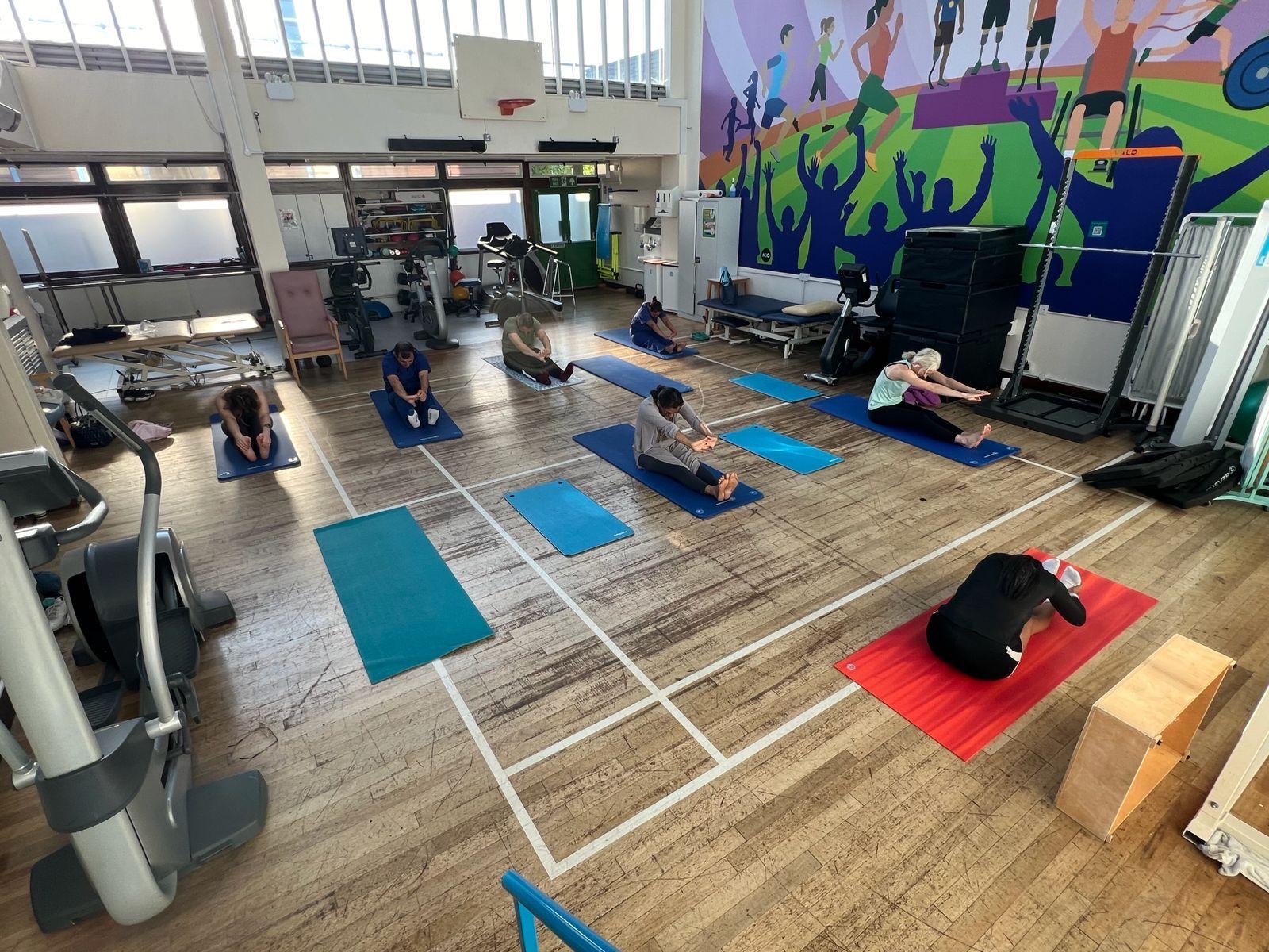 Yoga class practising in a sports hall